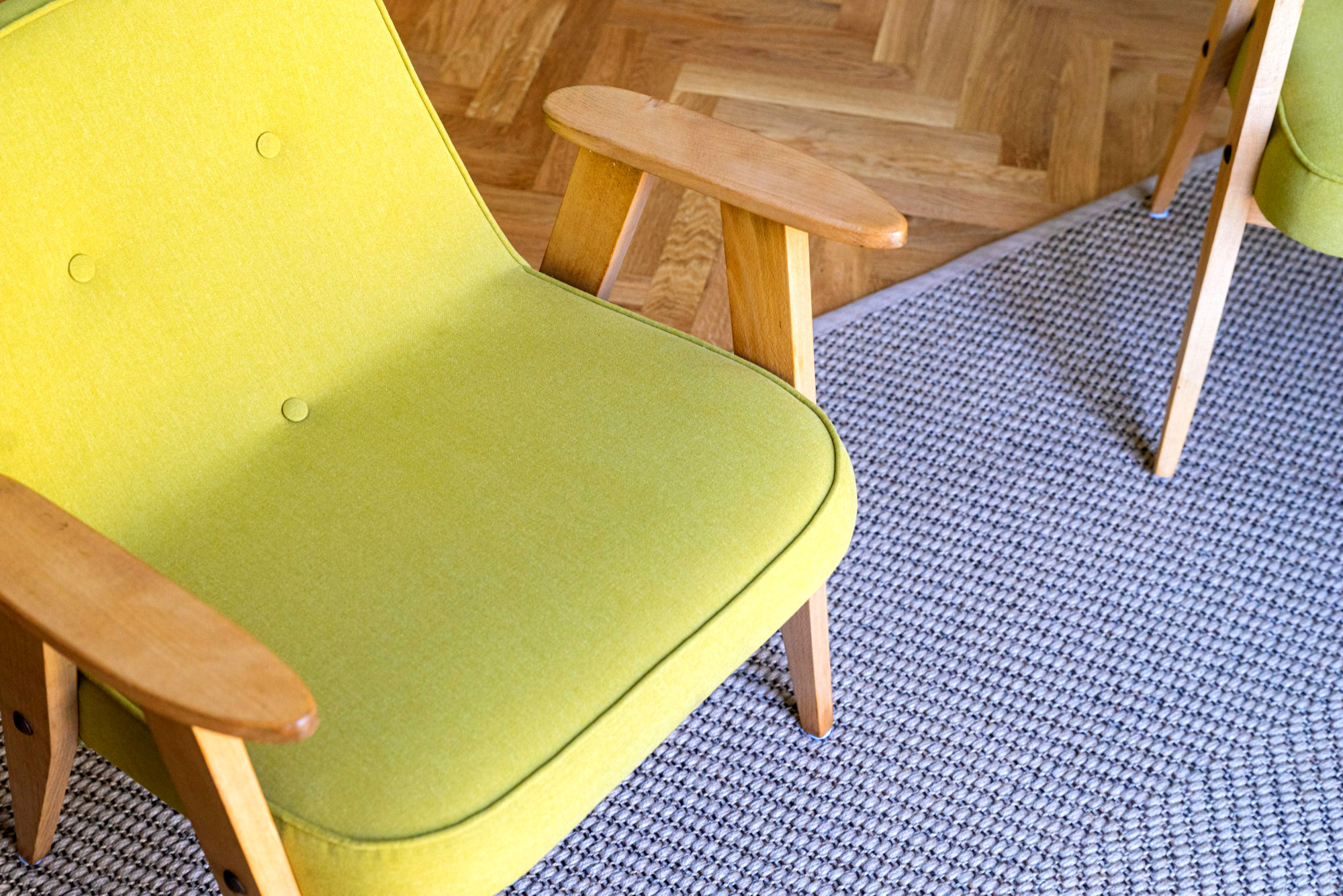 Blue rug on herringbone flooring